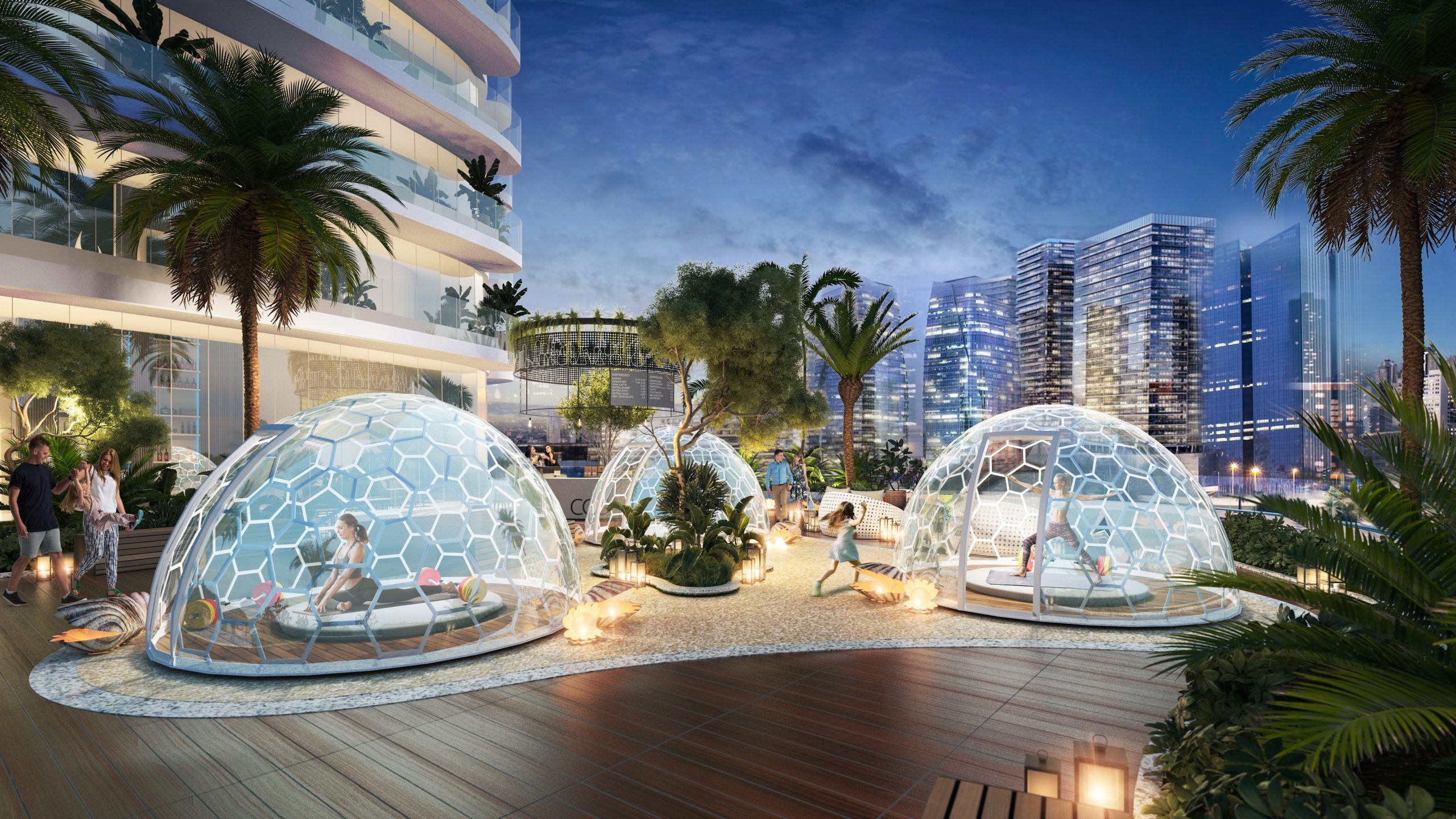 Glamping pods on the podium level with city skyline views at dusk