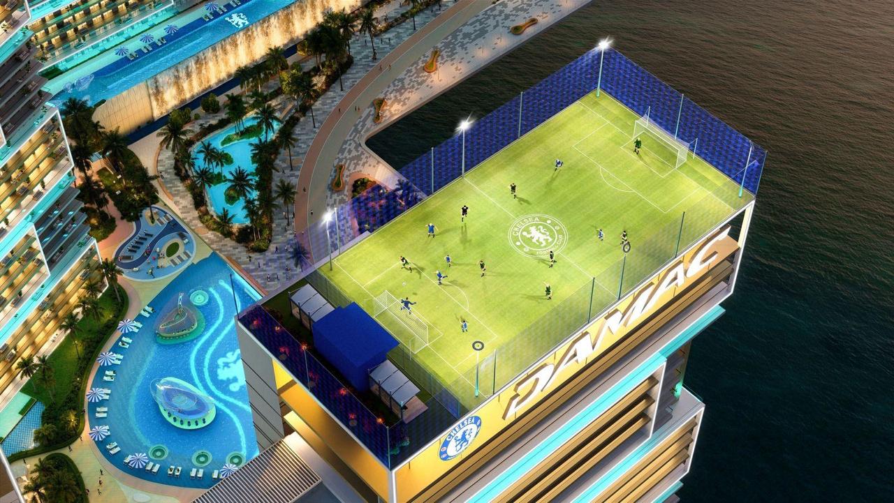 Rooftop football pitch with Chelsea FC crest, aerial view of waterfront