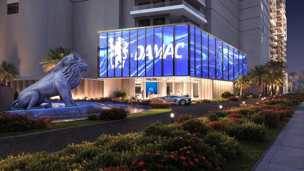 Chelsea x DAMAC entrance with lion statue and illuminated facade